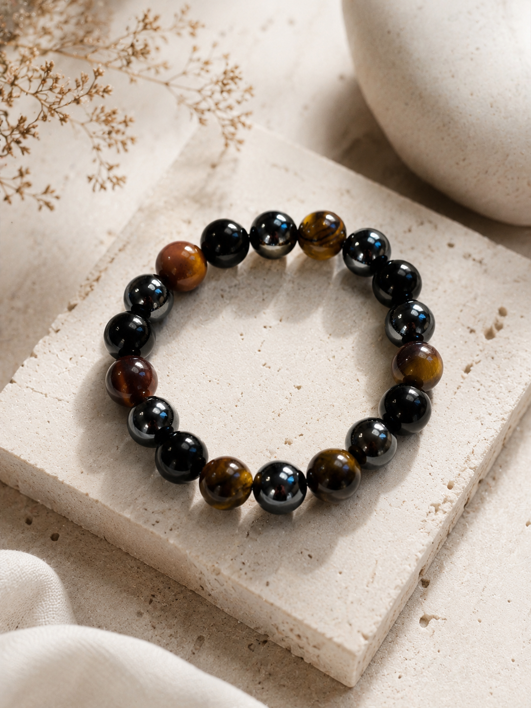 Close-up of tiger eye, black tourmaline and hematite protection bracelet beads