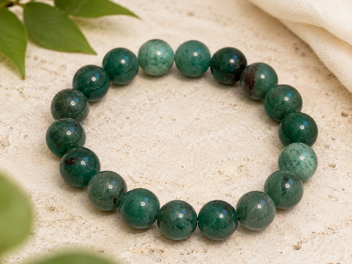 Green Aventurine bracelet displayed on a dish