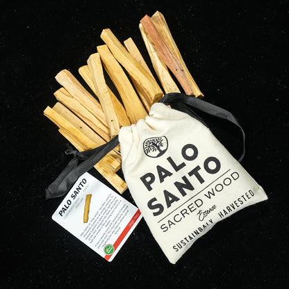 Bundle of palo santo sticks standing upright with the cotton pouch and guidance card