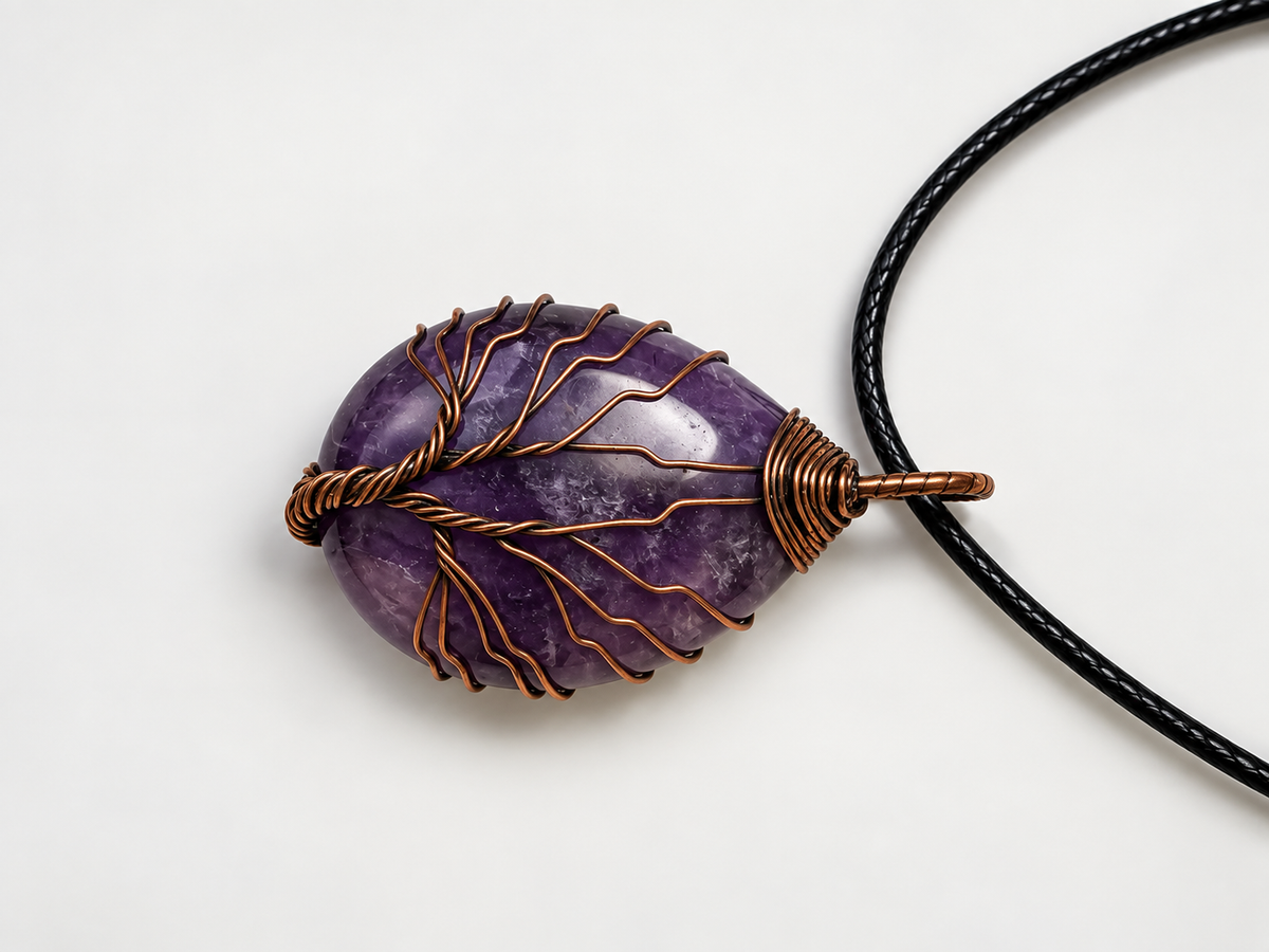 Natural amethyst teardrop wrapped in a hand-shaped wire Tree of Life