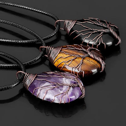 Three Tree of Life pendant necklaces close up - a dark stone, tiger eye and amethyst - showing the wire wrapping detail