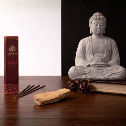 Buddha statue with incense, and palo santo wood stick